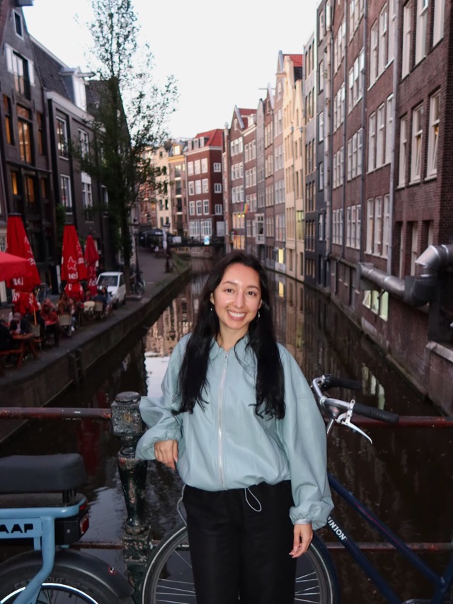Carissa Quinones smiling on a canal bridge in Amsterdam